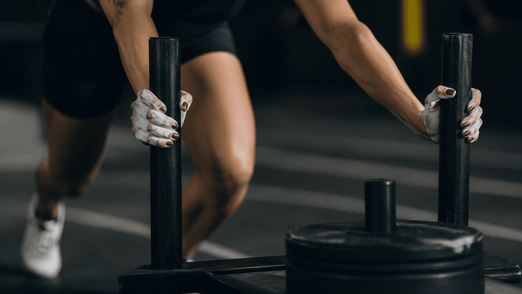 Athlete pushing a weighted sled